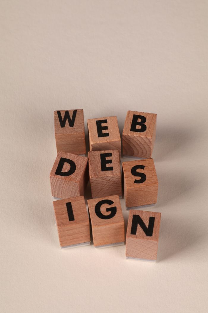 Wooden blocks set out to spell Web Design. Ideal for themes centered on creativity and digital content.